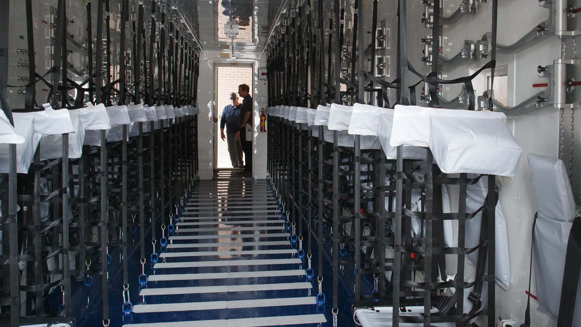 picture of two people walking into a storage room full of hardware and equipments