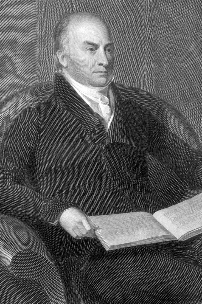 A black and white engraved portrait of a distinguished middle-aged man seated in what appears to be an armchair. He wears formal attire including a dark jacket and white cravat typical of the early 19th century. He is shown in a three-quarter pose with an open book in his hands, suggesting he may be a scholar, writer, or statesman. The engraving technique uses fine cross-hatching to create texture and dimension.
