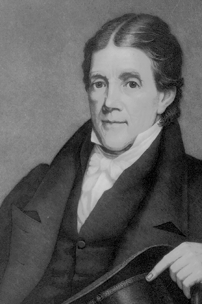 A black and white portrait of a man from the early 19th century. He has dark hair with a center part, and wears formal attire including a dark coat and white cravat or necktie. His expression is composed and serious, and he appears to be resting his hand on what might be a book or document. The portrait style suggests this is from approximately the 1820s-1840s.