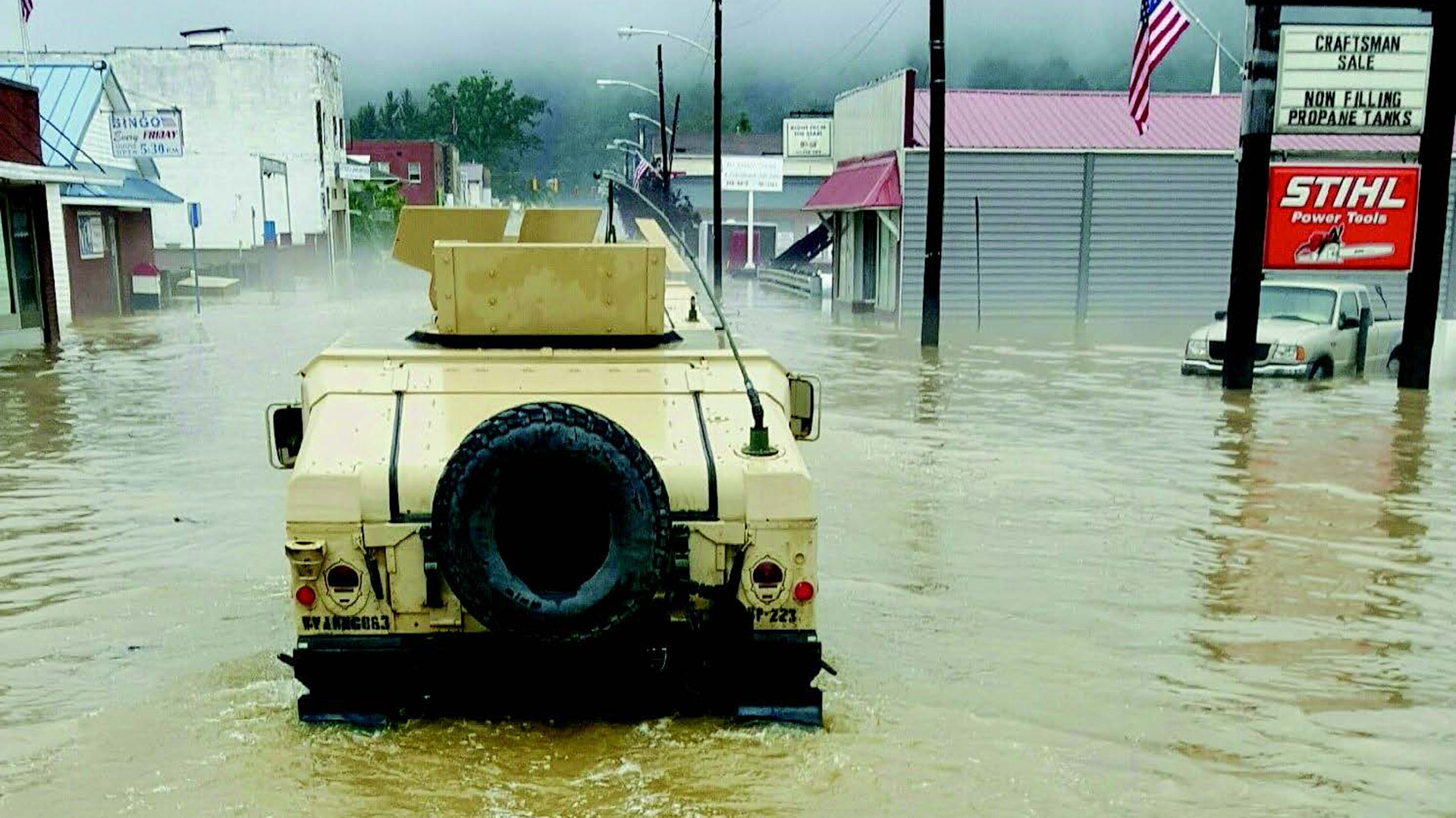 picture of a military vehicle from the 811th ordnance company performing rescue operations to support local population during flooding.