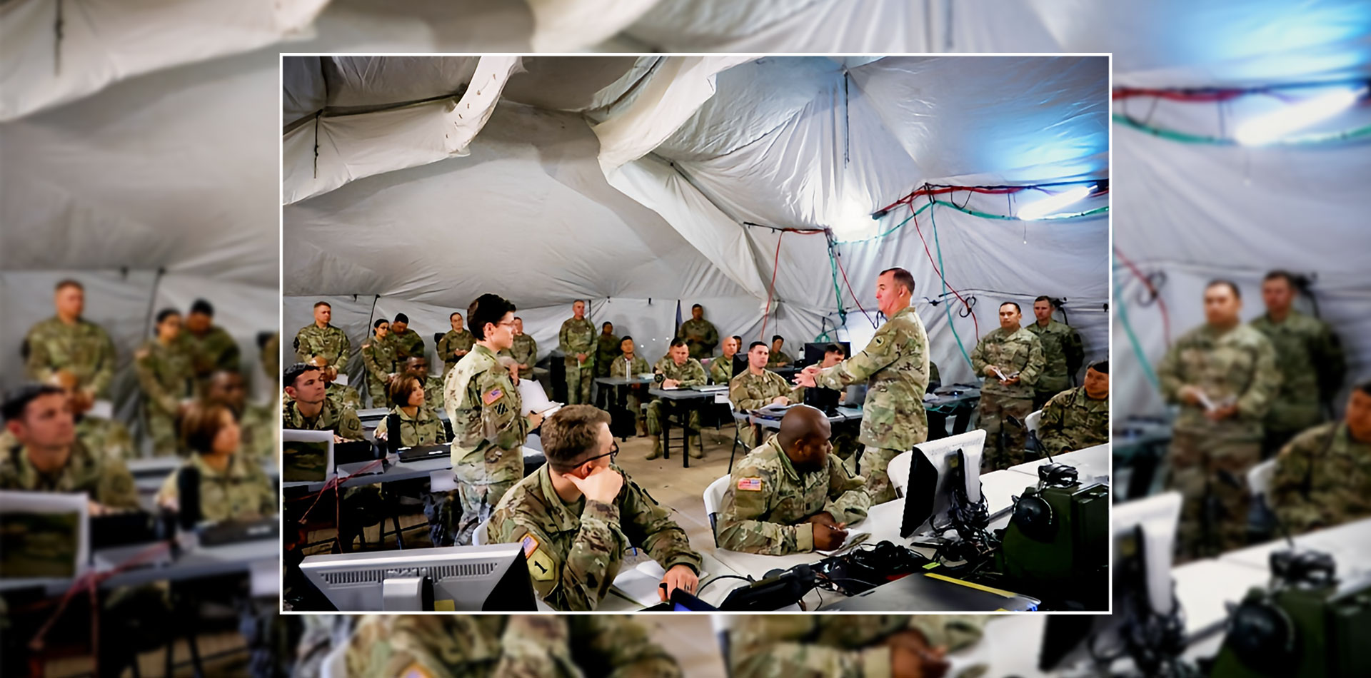 Soldiers conduct a briefing inside a tactical operations tent.