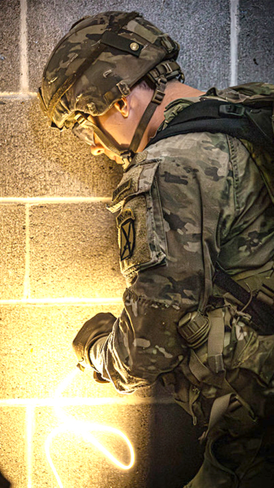 A Soldier looks down with a light source