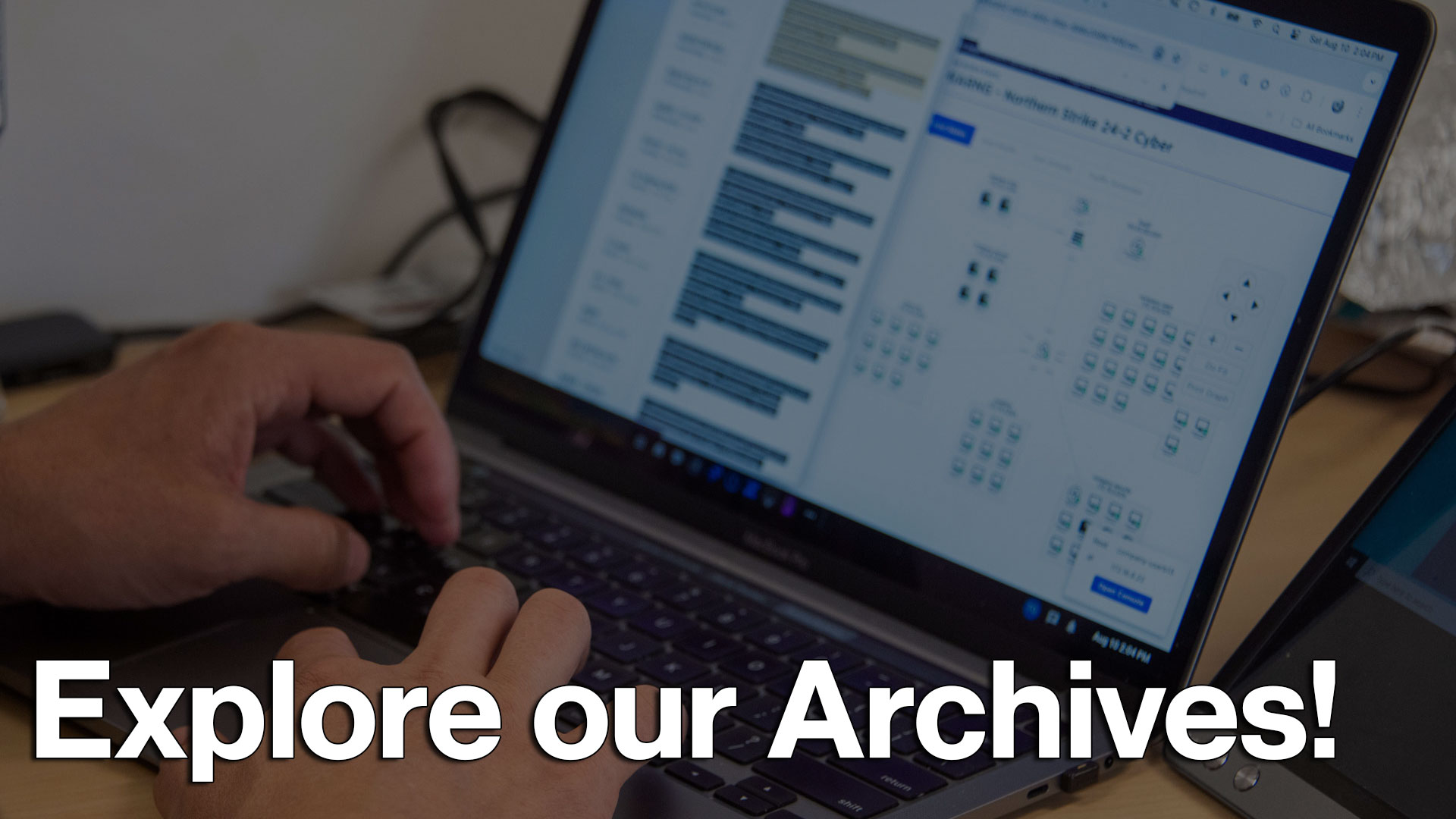 Explore our Archives text overlay on image of person using laptop displaying cyber training interface with multiple learning modules and interactive grid elements. Hands visible on keyboard, headphones nearby on desk.