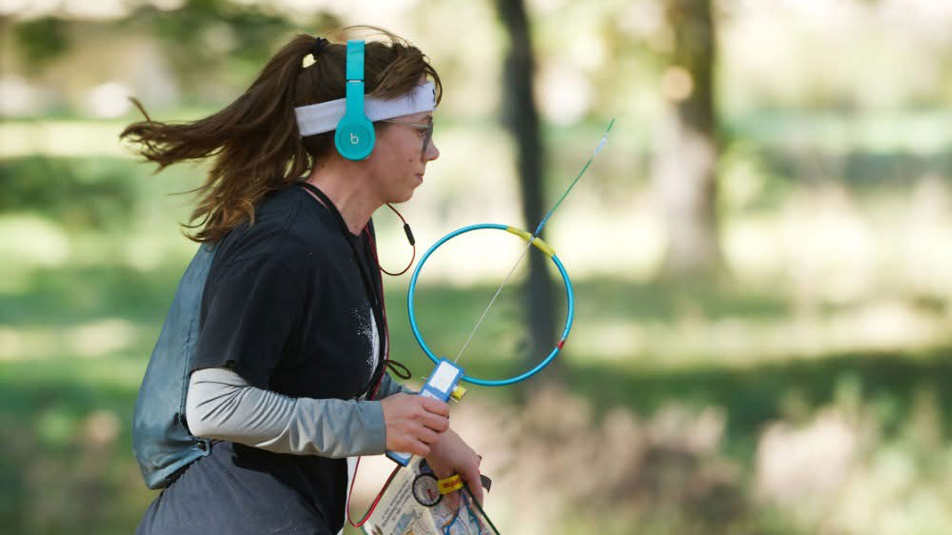 A participant in the amateur radio direction finding competition is racing through a course to locate their next beacon.
